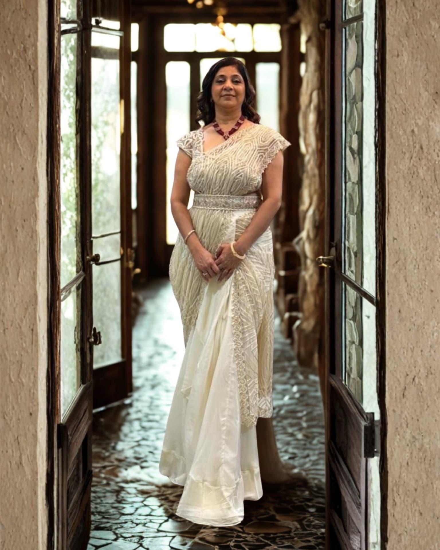 Tejal in an elegant ivory saree at a heritage doorway