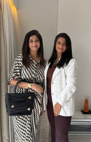 Two women styled in elegant coordinated outfits for a personal shopping consultation