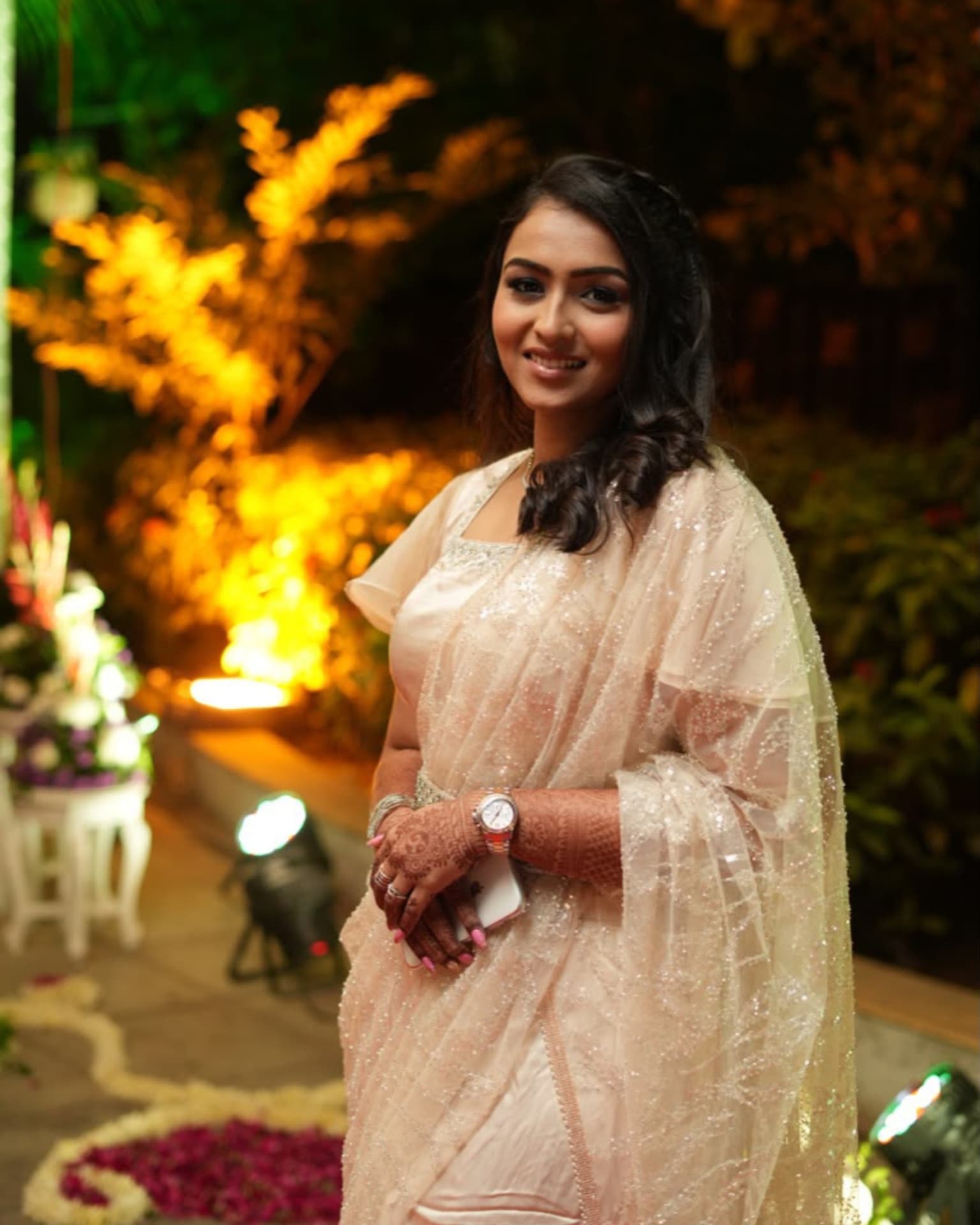 Tejal in an elegant blush pink saree at a wedding celebration